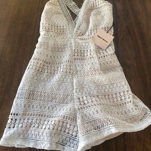 White, textured romper. NWT.